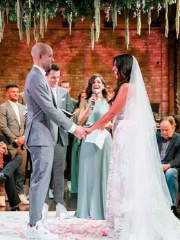 Brad Hoss with his wife Stephanie Beatriz taking their wedding vows